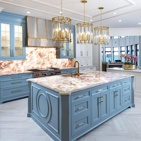 Glowing Elegance blue kitchen with patterned stone countertops and warm metallic pendant lighting