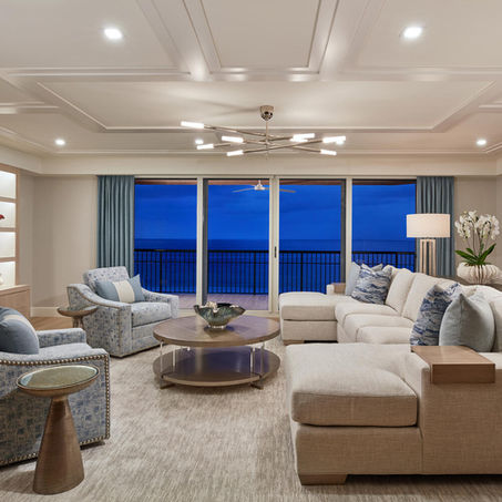 Southern Charm traditional living room with neutral upholstered seating, layered lighting and expansive windows