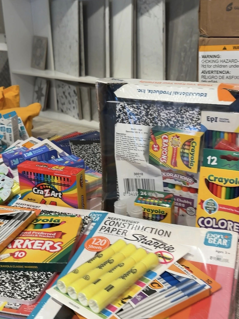 Donated school supplies, including notebooks, crayons, markers, and highlighters, collected for the Naples Back-to-School Supply Drive benefiting children served by St. Matthew’s House.