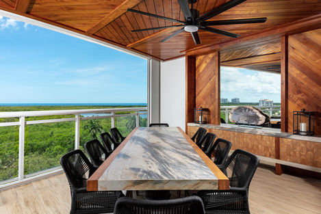 a large table with a marble top vintage and modern twist eclectic design, bold patterns, vibrant accents, Kalea Bay Naples FL