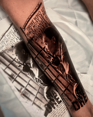 Tattoo of Martin Luther king on inner calf in Black and White Realism by APZ in Copenhagen, Denmark.In Copenhagen, APZ is a skilled tattoo artist trained by some of the best tattoo artists in the world. He specializes in classic realism tattoos using a modern black and white style, focusing on connected designs and full sleeve tattoos that enhance his clients’ style. His Martin Luther king tattoo on inner calf speaks volumes with lifelike realistic details.