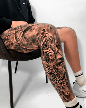 Tattoo of animals-leopard, tiger and eye on the full leg in Black and White Realism by APZ in New York, US.In New York, APZ is a skilled tattoo artist trained by some of the best tattoo artists in the world. He specializes in classic realism tattoos using a modern black and white style, focusing on connected designs and full sleeve tattoos that enhance his clients’ style. His animals-leopard, tiger and eye tattoo on full leg speaks volumes with lifelike realistic details.