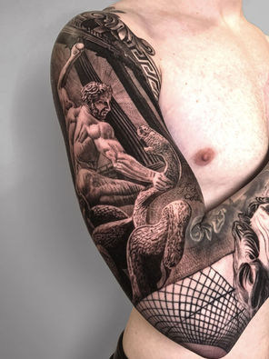 Tattoo of statue Hercules snake and Zeus on full arm sleeve in Black and White Realism by APZ in New York, US.In New York, APZ is a skilled tattoo artist trained by some of the best tattoo artists in the world. He specializes in classic realism tattoos using a modern black and white style, focusing on connected designs and full sleeve tattoos that enhance his clients’ style. His sculpture Hercules snake and Zeus tattoo on full arm speaks volumes with lifelike realistic details.