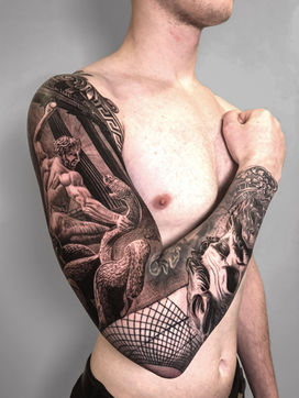 Tattoo of statue Hercules snake and Zeus on full arm sleeve in Black and White Realism by APZ in New York, US.In New York, APZ is a skilled tattoo artist trained by some of the best tattoo artists in the world. He specializes in classic realism tattoos using a modern black and white style, focusing on connected designs and full sleeve tattoos that enhance his clients’ style. His sculpture Hercules snake and Zeus tattoo on full arm speaks volumes with lifelike realistic details.