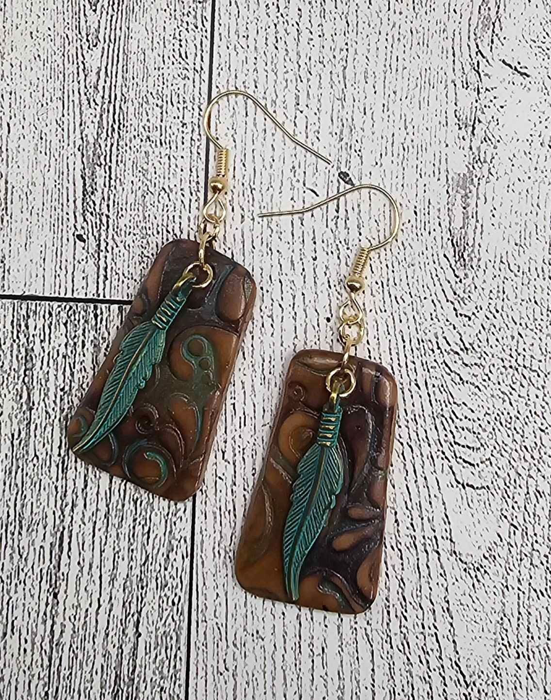 faux tooled leather and feathers