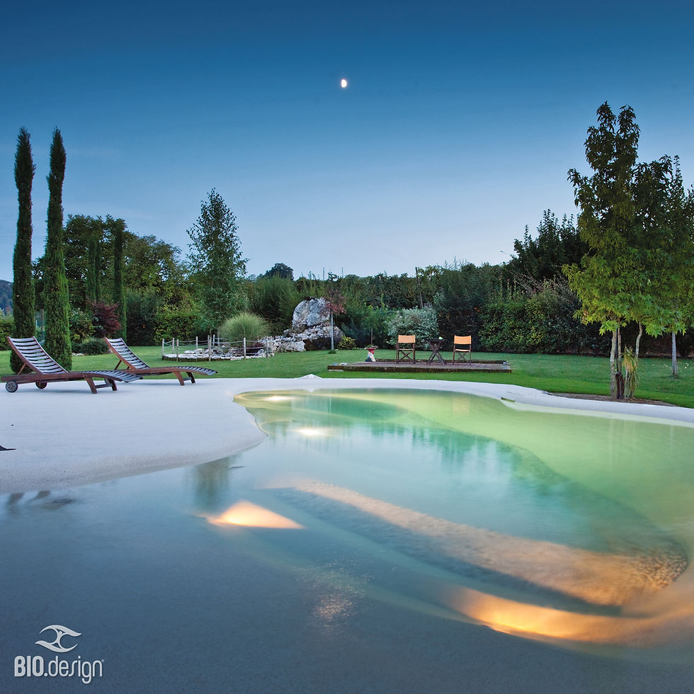 Lagoon pool builder NSW natural stone pool at dusk