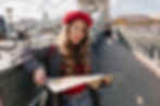 Woman exploring Prague with a city map, finding local deals nearby