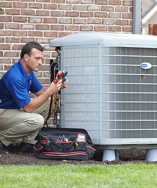 homeguide-ac-contractor-checking-gauges-on-carrier-ac-unit.jpeg
