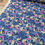 Thumbnail: Floral fabric with a blue background and colorful flower patterns.
