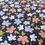 Thumbnail: Floral fabric with orange, blue, and white flowers on a dark background 