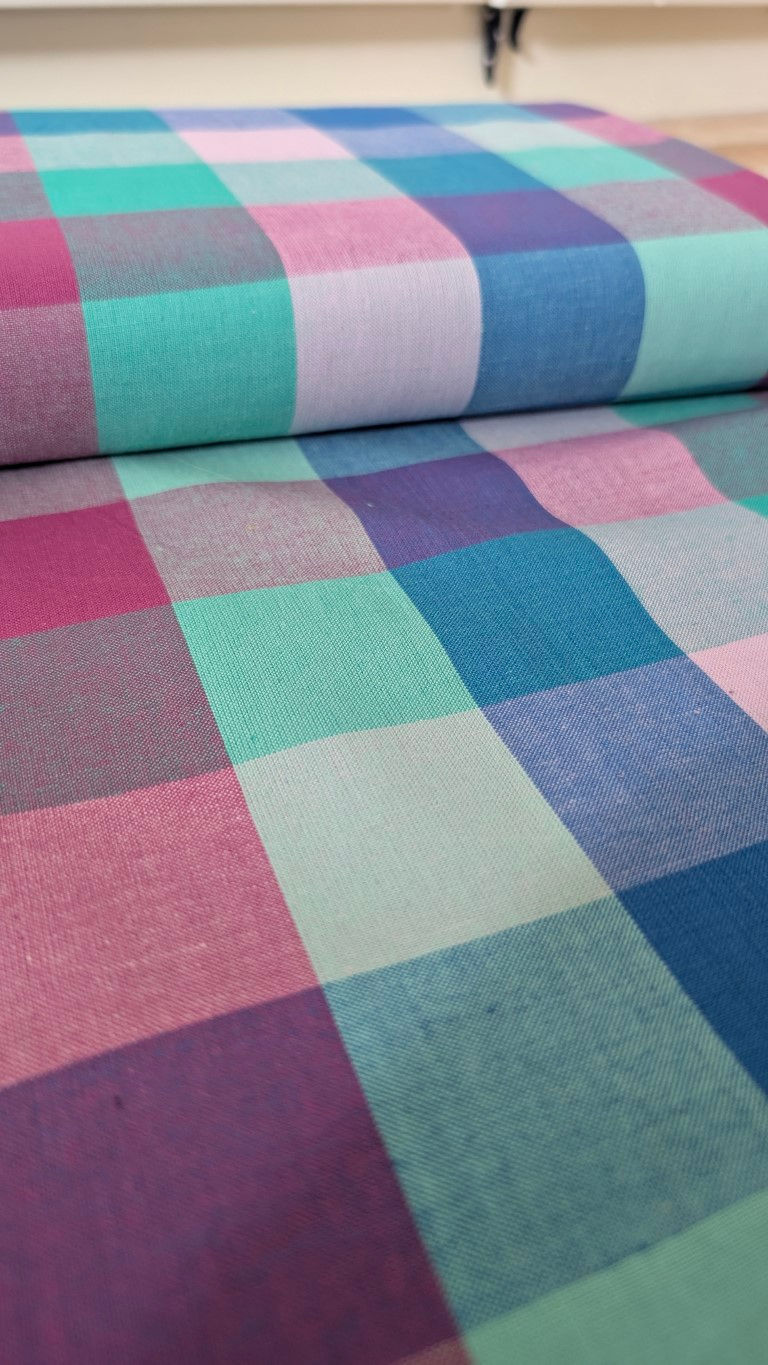 Thumbnail: Colorful plaid fabric with pink, teal, and blue squares, folded Nightfall Forest cotton.