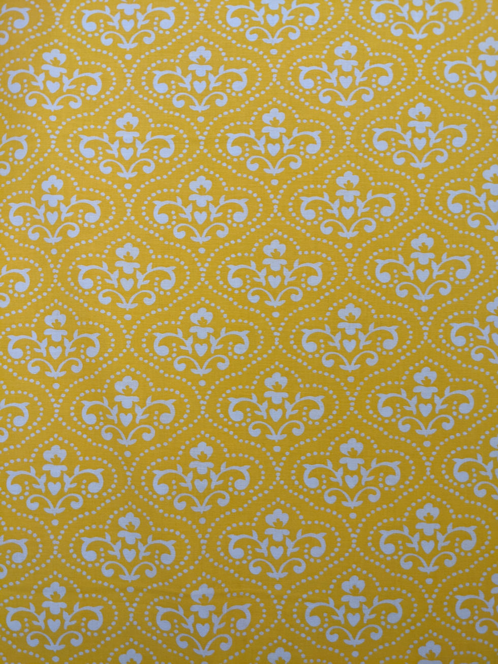 Thumbnail: Yellow patterned fabric with white floral design, textile background texture design.