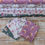Thumbnail: Floral fabric stacks with daisies, Red Floral Fabric - Rainbow Garden Organic Cotton The Crafty Lass, The Fabric Squirrel.