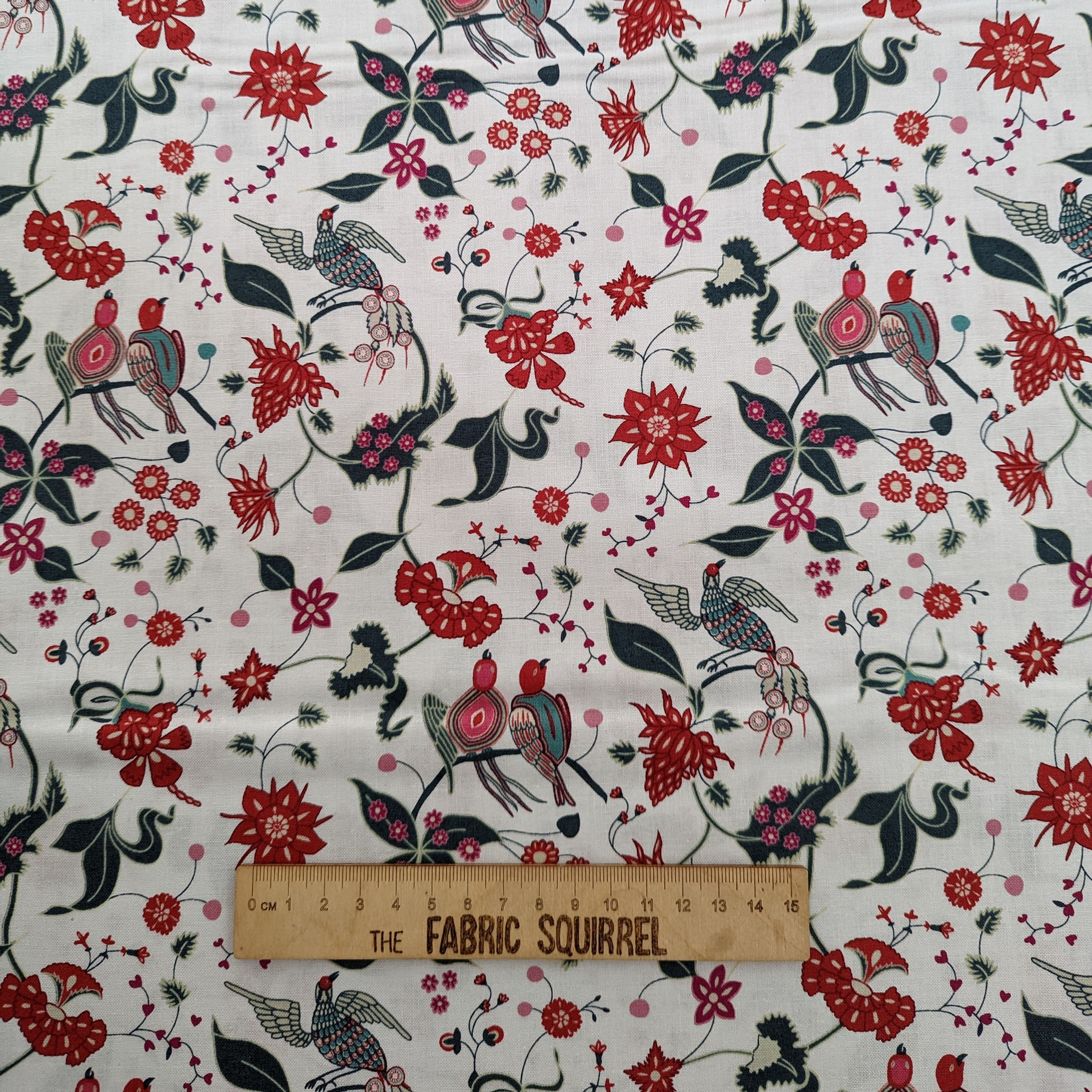 Fabric with birds, flowers, and The Fabric Squirrel ruler; festive print.