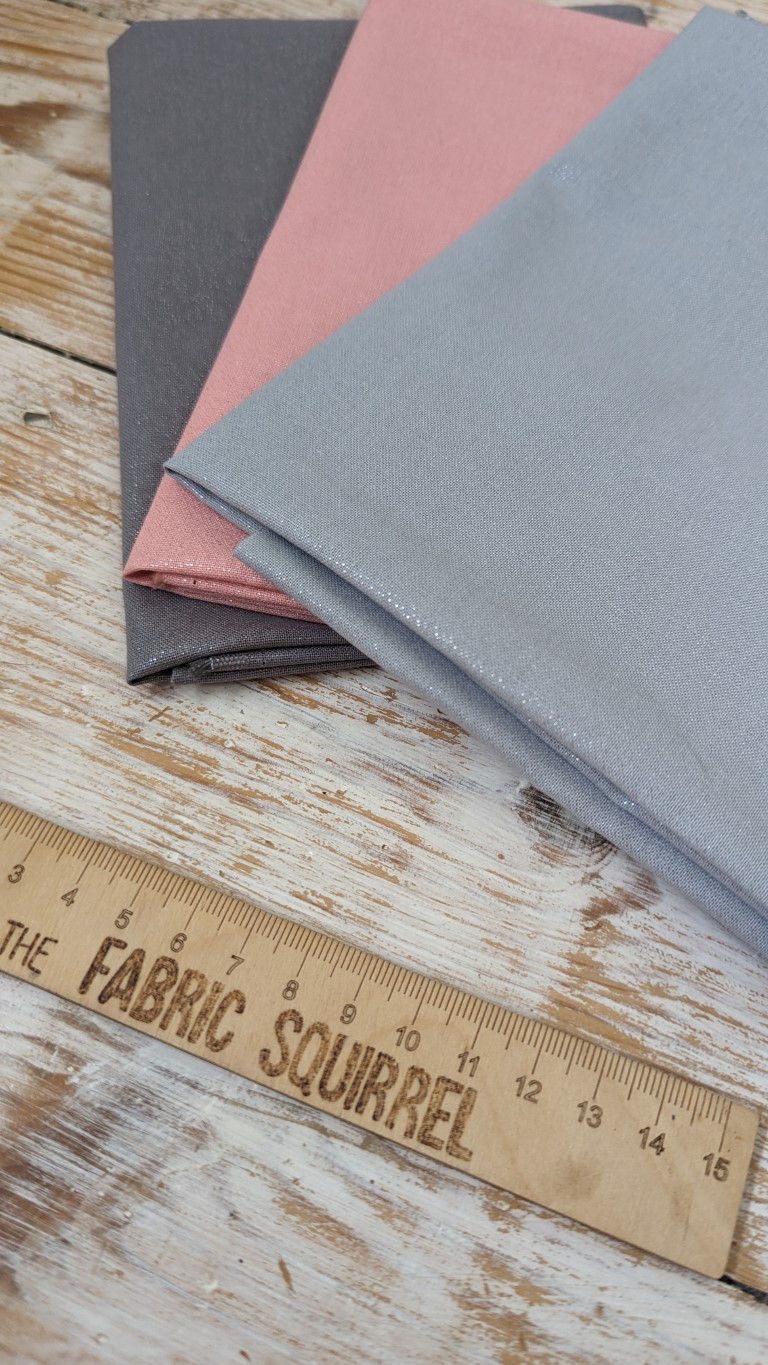 Thumbnail: Folded fabric with ruler, Mid Grey Shimmer Fabric - 100% Cotton, on wooden background The Fabric Squirrel