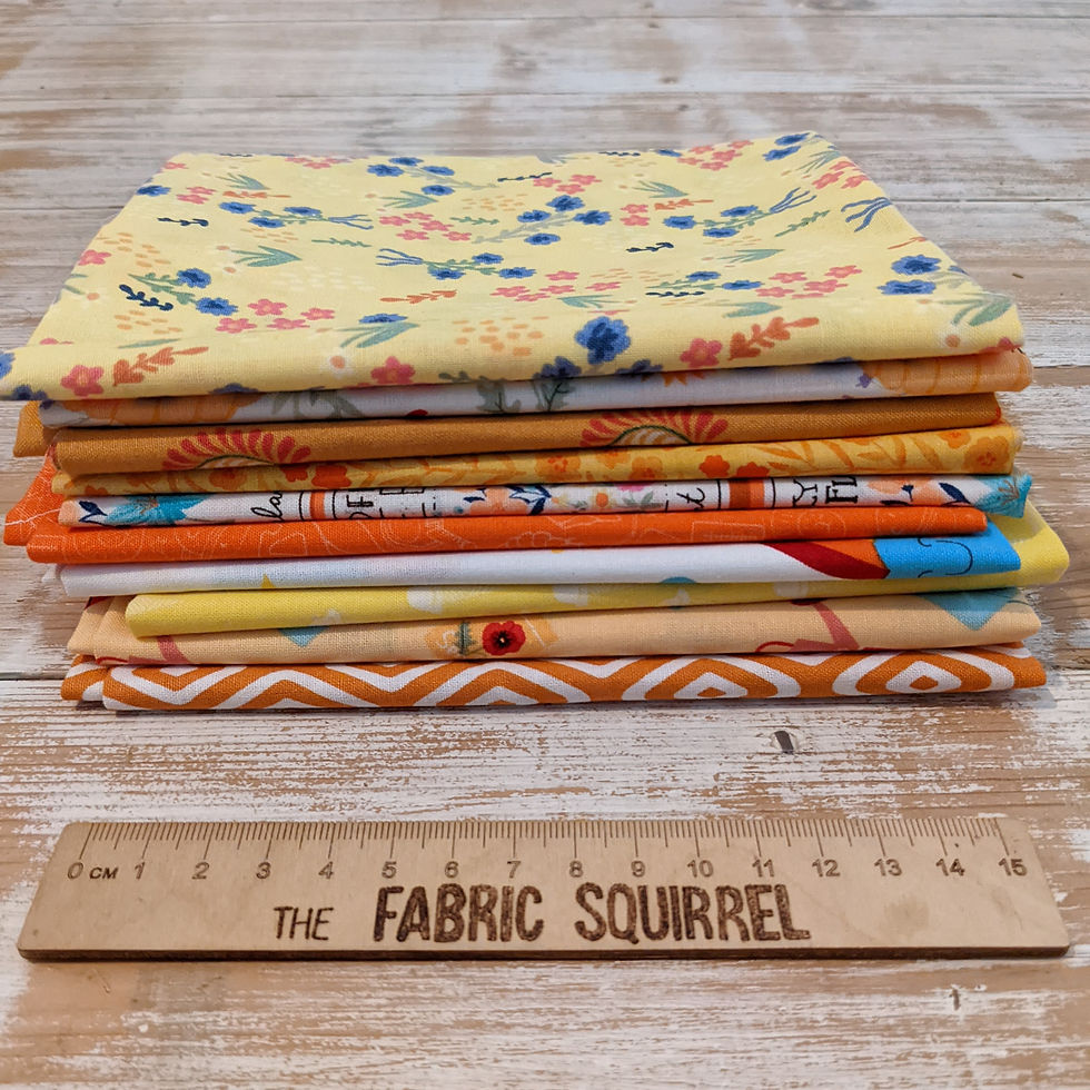 Thumbnail: Fabric stack with various patterns and colors, including The Fabric Squirrel ruler.