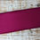 Thumbnail: Folded piece of solid magenta fabric on a rustic wooden surface backdrop. The Fabric Squirrel