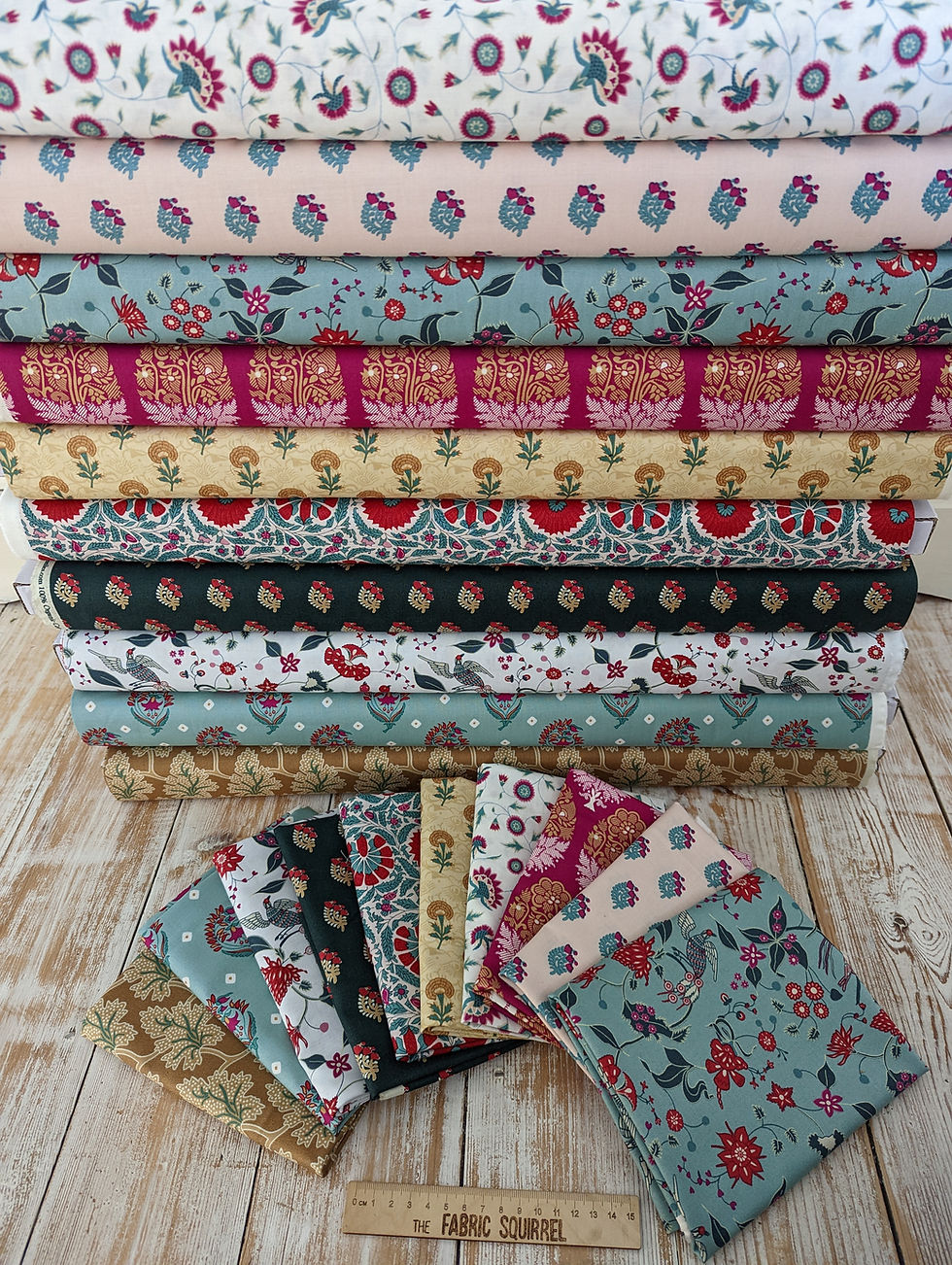 Thumbnail: Stacked fabric rolls with floral patterns in various colors, Pencil Stay Sharp Fabric.