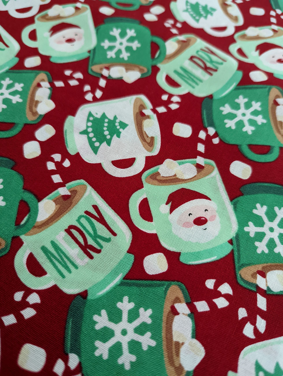 Thumbnail: Fabric with illustrated mugs, marshmallows, and text: Merry Christmas.