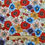 Thumbnail: Floral fabric with red, blue, and orange flowers, Fabric Squirrel on ruler background.