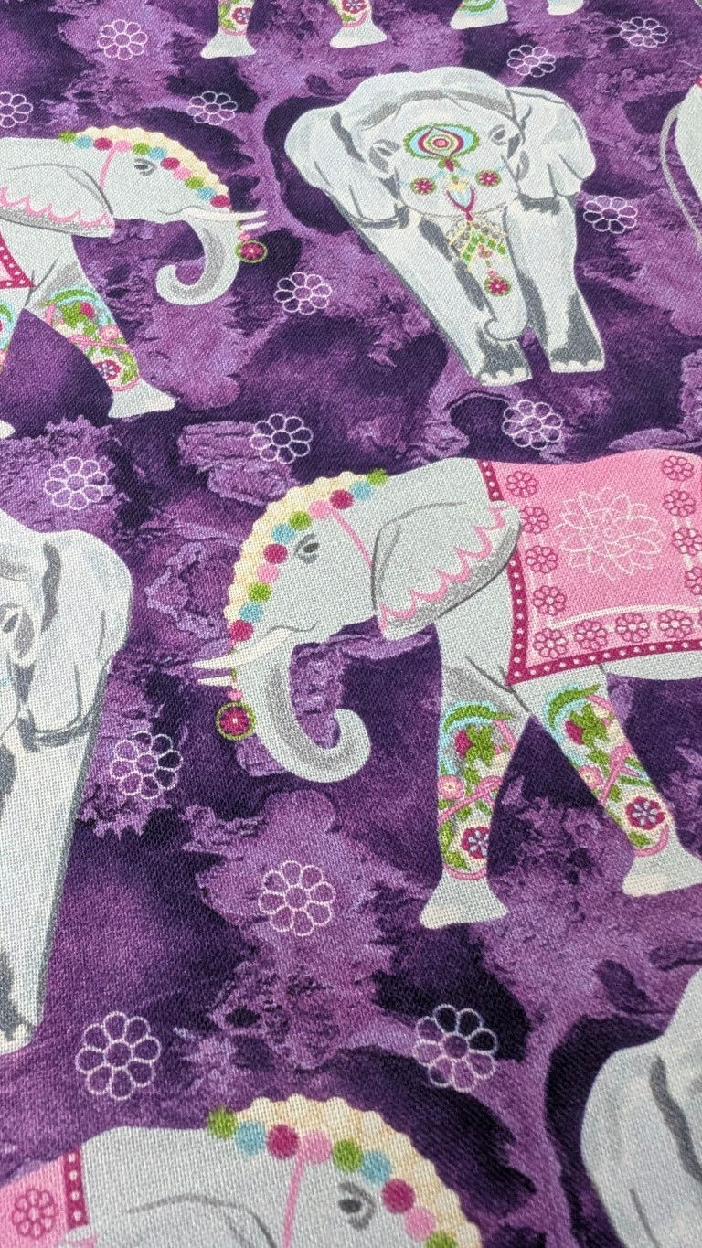 Thumbnail: Purple fabric with white elephants and floral details; Elephant Festival Fat Quarter Bundle.