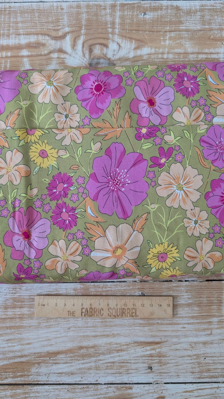 Thumbnail: Floral fabric with large pink flowers and assorted colors on green background. The Fabric Squirrel