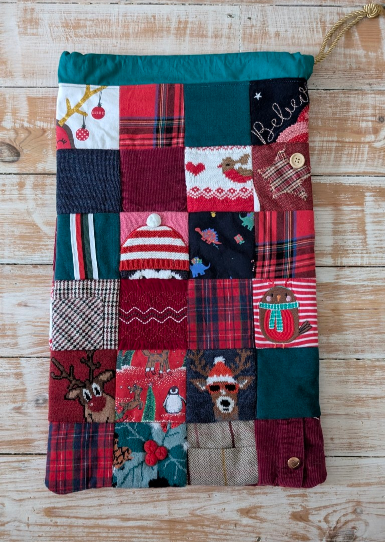 Thumbnail: Quilted Christmas sack with various festive fabrics and patterns, festive decor.