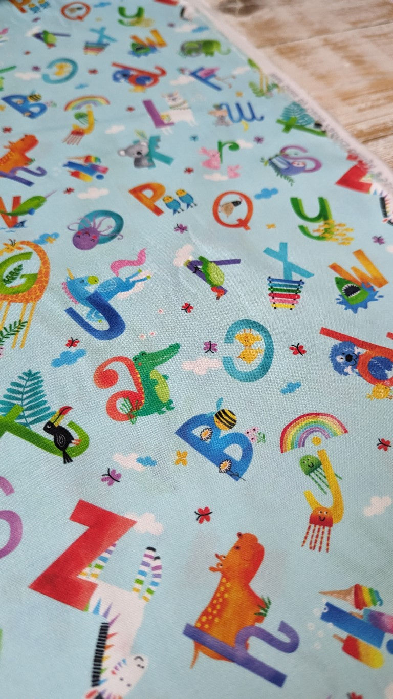 Thumbnail: Colorful fabric with letters, animals, and Summer Creatures on Duck Egg Blue Fabric.