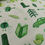 Thumbnail: Green fabric with various green illustrations including car and book.