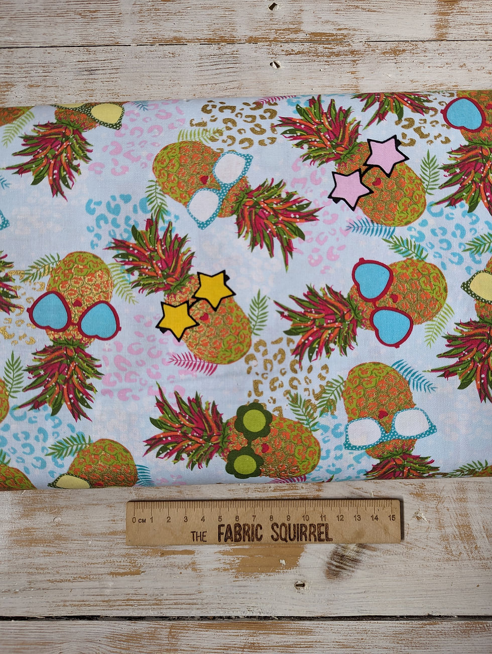 Thumbnail: Pineapple fabric with sunglasses The Fabric Squirrel design on ruler.