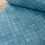 Thumbnail: Rolled blue fabric with white patterned design. The Fabric Squirrel