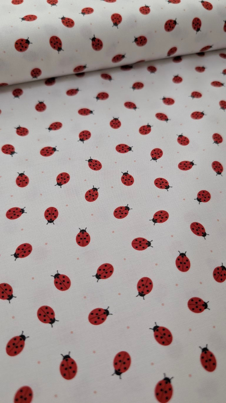 Thumbnail: White fabric scattered with red ladybugs, an adorable springtime textile design.