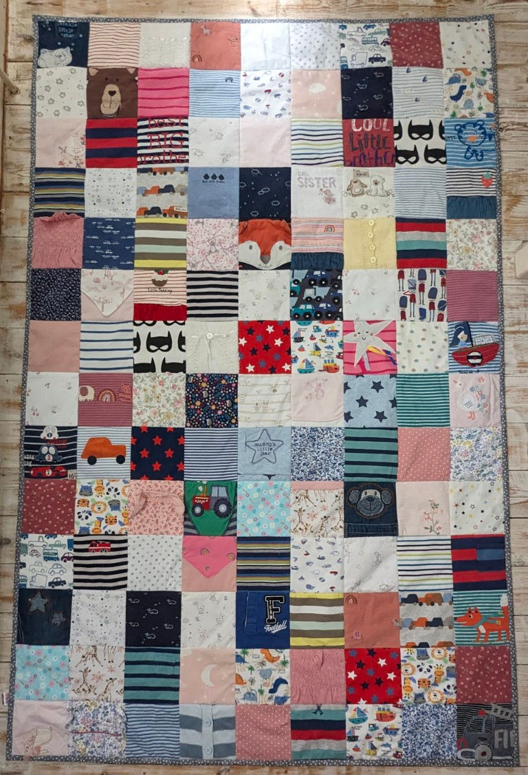 Thumbnail: Original keepsake quilt made up of 6" patches. Made up of baby  clothes.