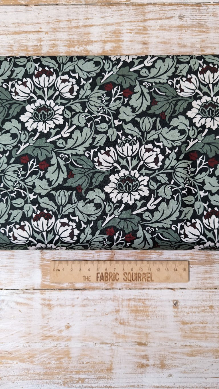 Floral fabric with white and green flowers, berries, and text by The Fabric Squirrel.