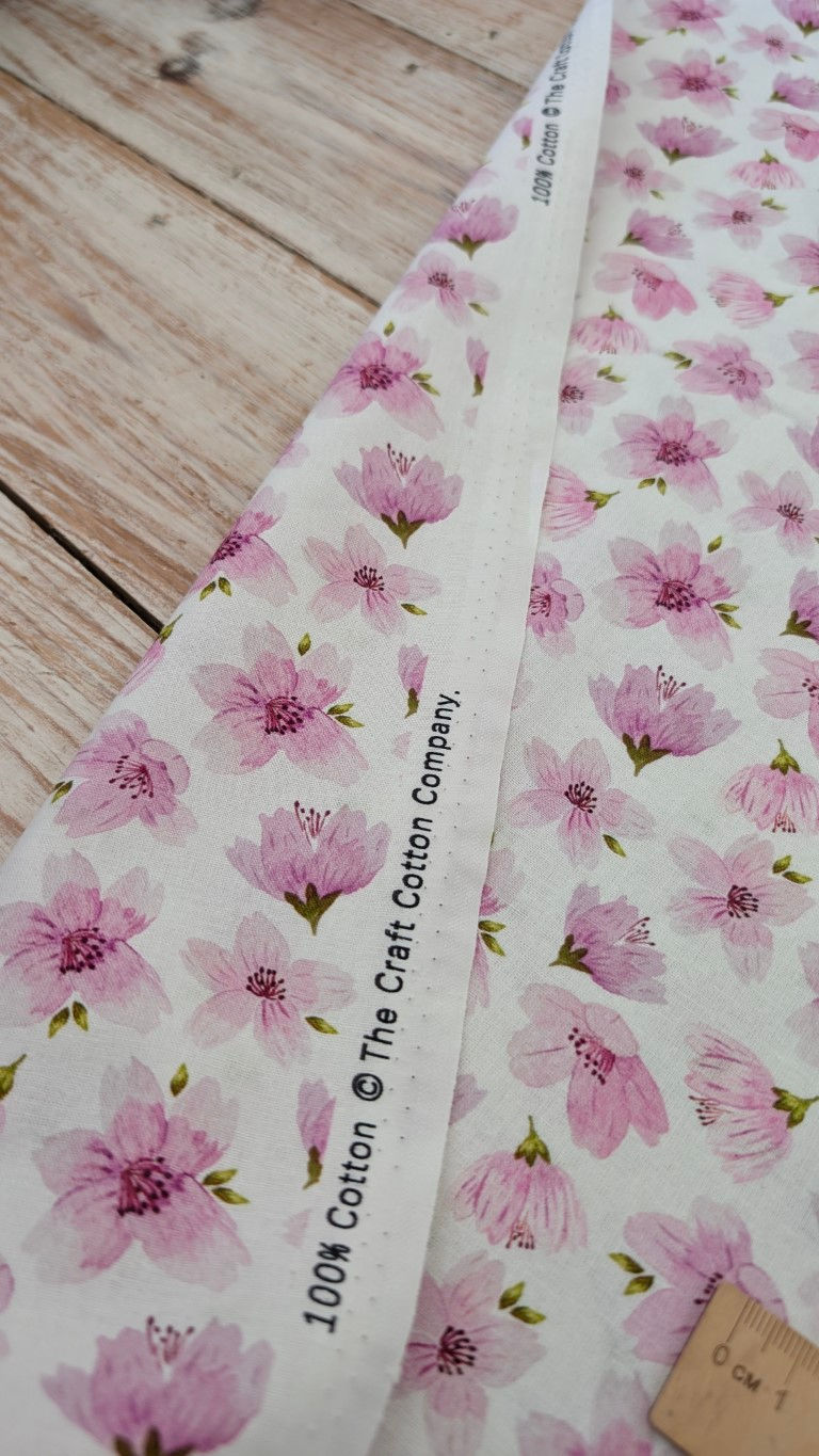 Thumbnail: White fabric with pink floral pattern; The Craft Cotton Company textile print