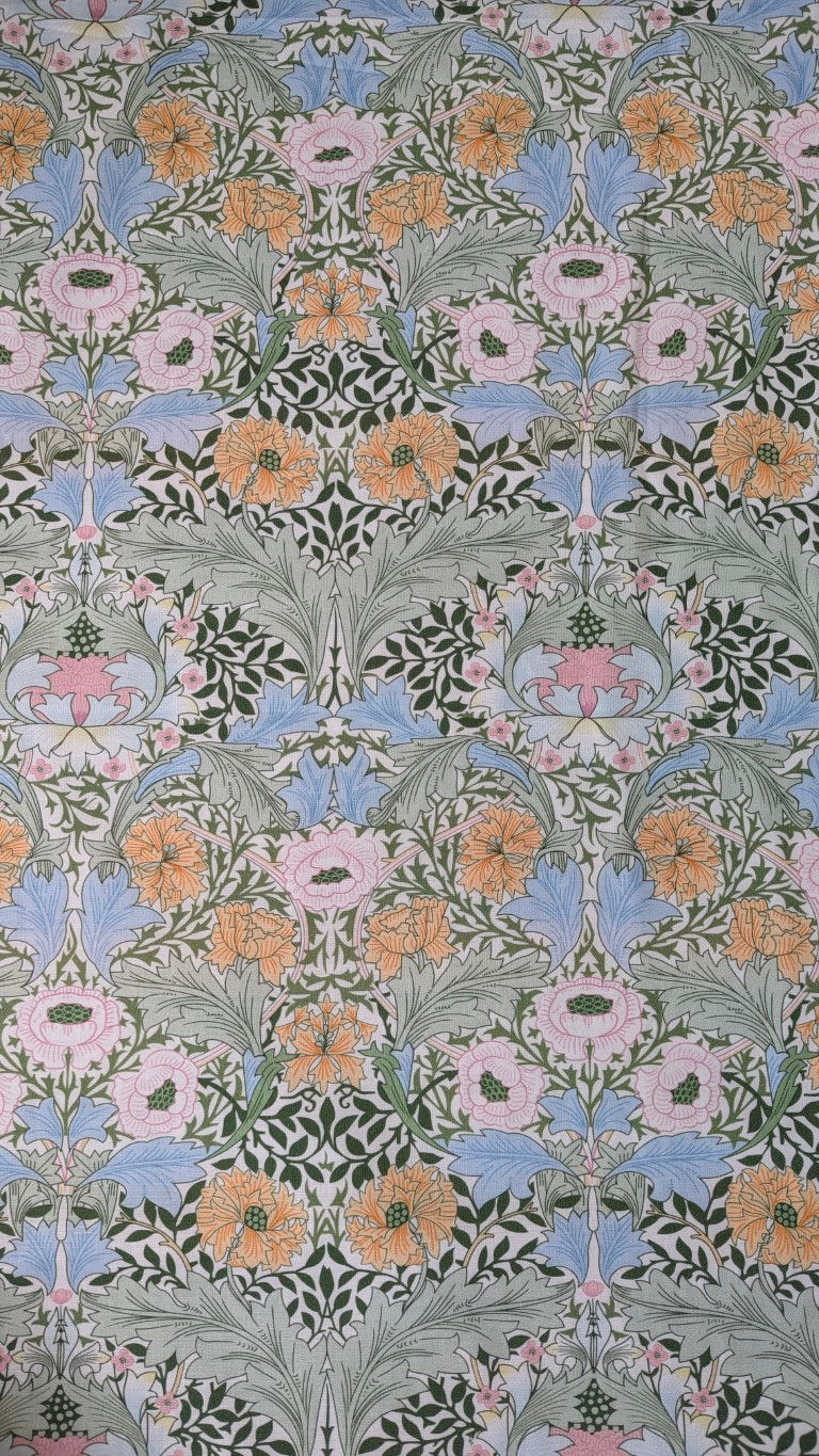 Thumbnail: Floral fabric repeating pattern in orange, pink, and blue; textile background detail.