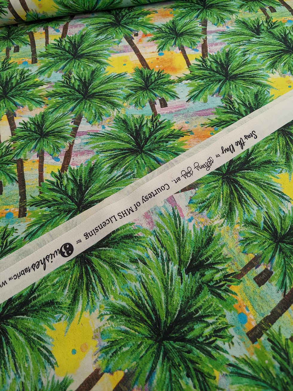 White fabric with text over a vibrant green palm tree background.