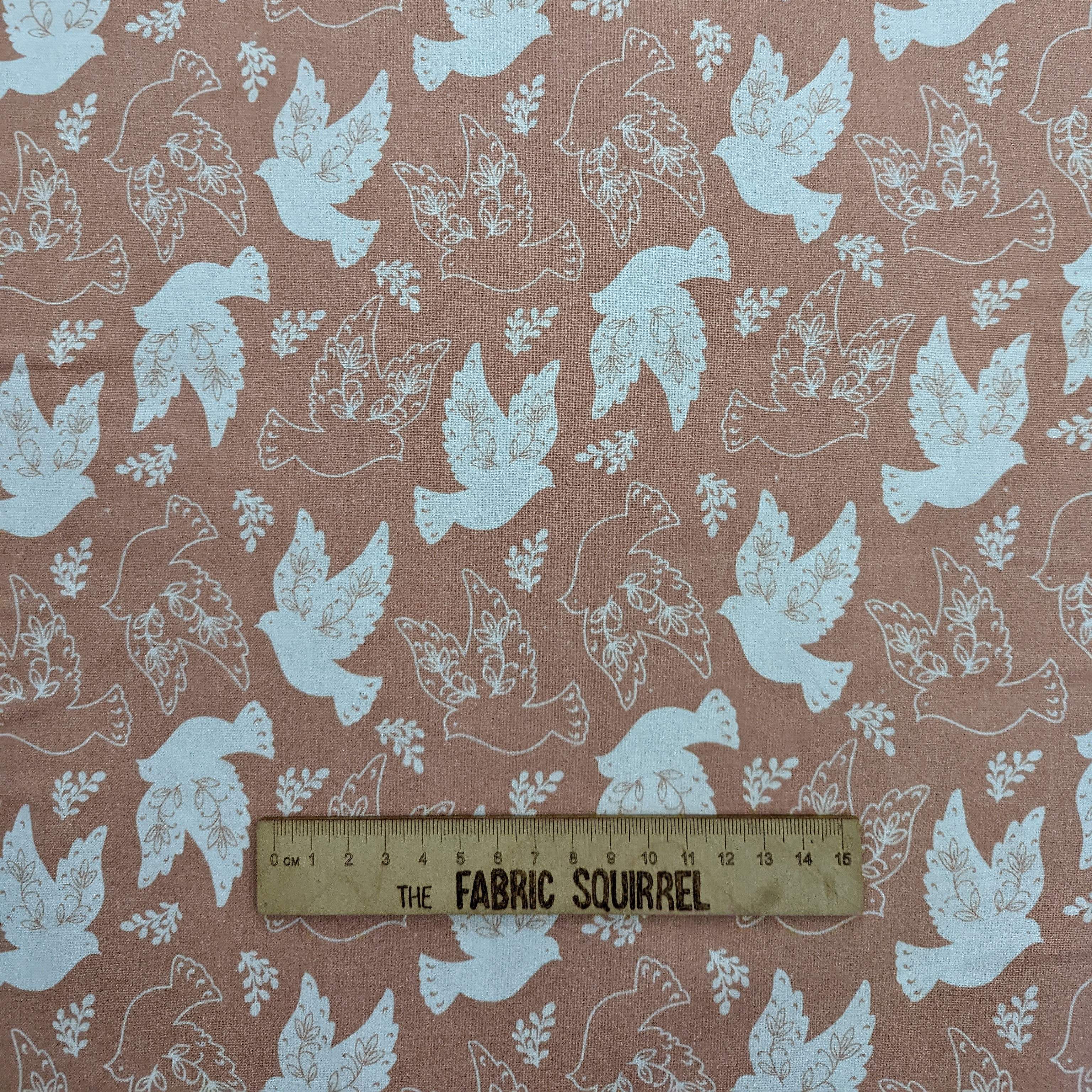 Fabric with white doves and leaves on a coral background, The Fabric Squirrel.