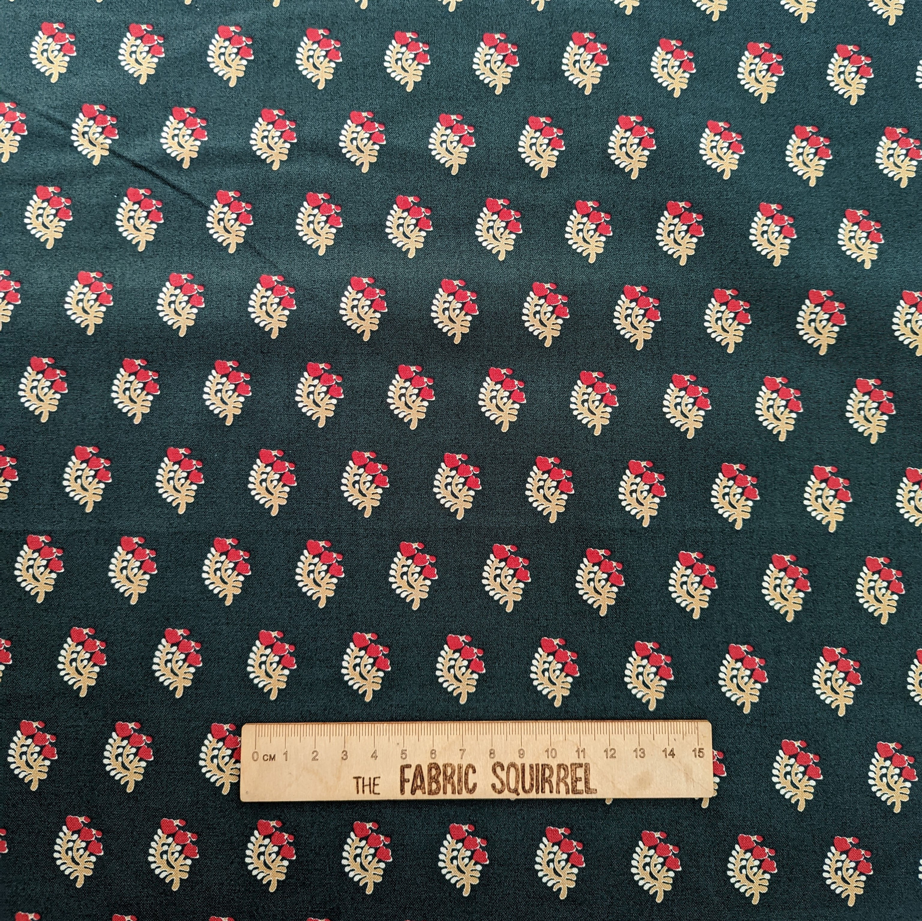 Dark green fabric with repeating floral pattern and a Fabric Count ruler.