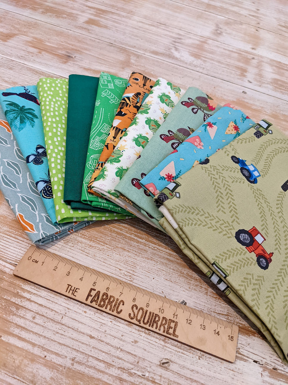 Thumbnail: Various colorful fabric patterns with tractor and car designs, The Fabric Squirrel.