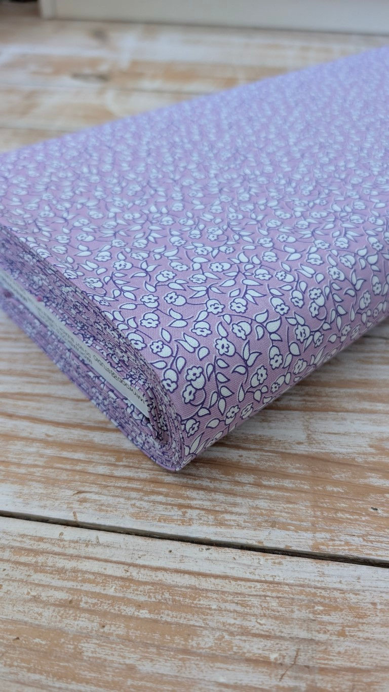 Thumbnail: Floral fabric folded, light purple with tiny white flowers. The Fabric Squirrel