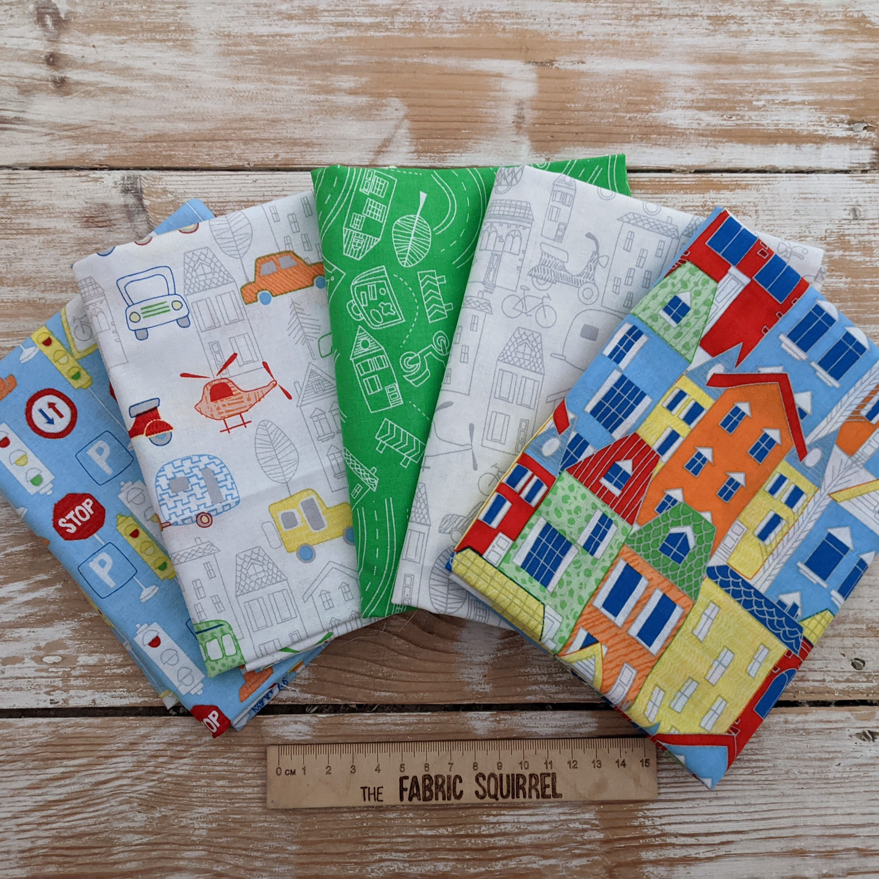 Various colorful fabric squares with patterns on wooden background, The Fabric Squirrel