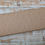 Thumbnail: Beige fabric with tiny dots, displayed on a wooden surface, The Fabric Squirrel