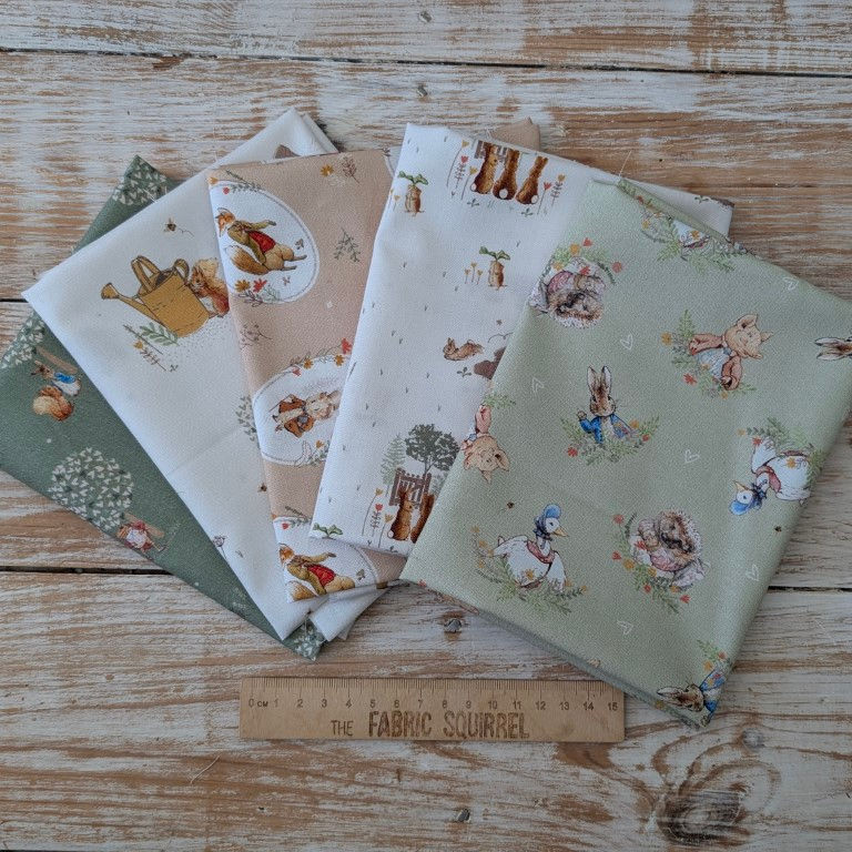 Thumbnail: Various colorful fabric patterns arranged on a wooden surface, ready for crafting projects.