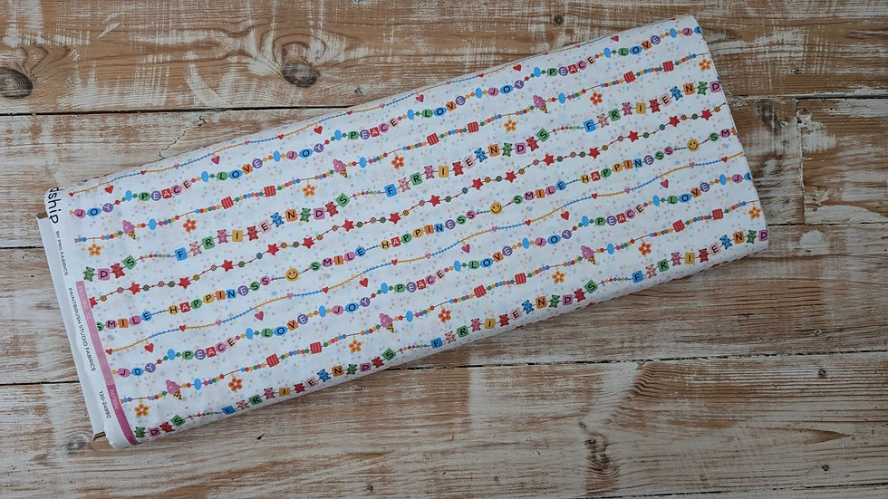 Thumbnail: White fabric roll with colorful garland pattern on a wooden background.