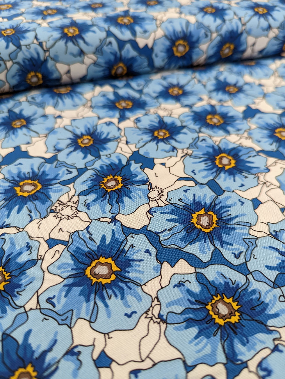 Close-up of blue floral fabric with white background, Jennie's Greens Collection.