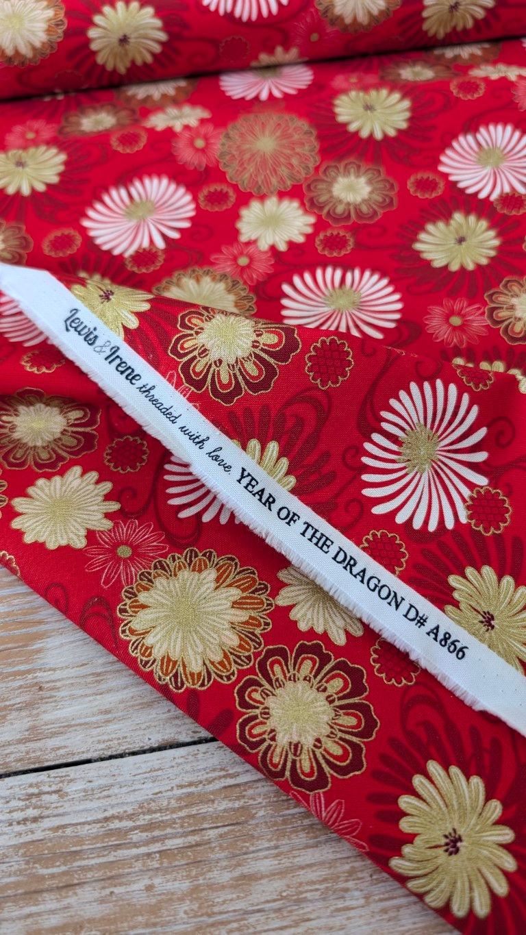 Thumbnail: White stick with text YEAR OF THE DRAGON D# A866 on red fabric.