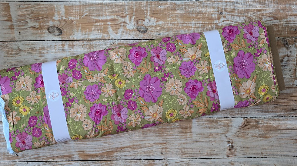 Thumbnail: Rolled fabric with pink flowers and green background. The Fabric Squirrel