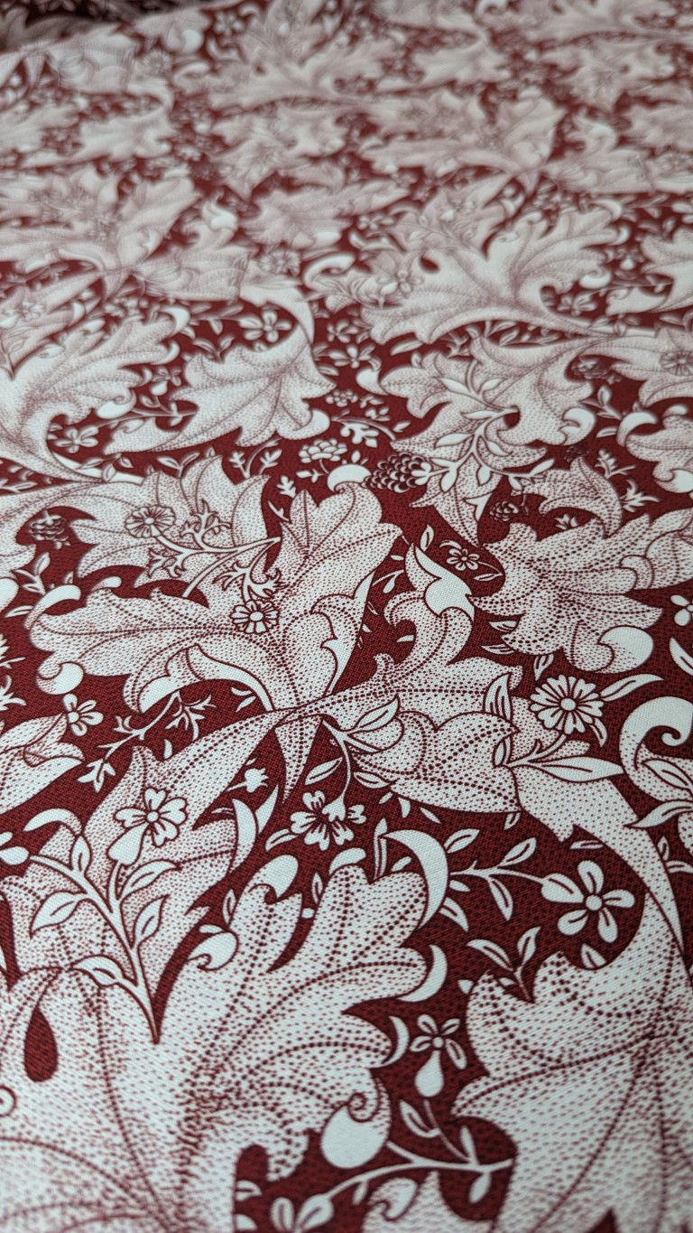 Thumbnail: Burgundy fabric with white floral pattern and leaves. British Birds on Green Fabric.