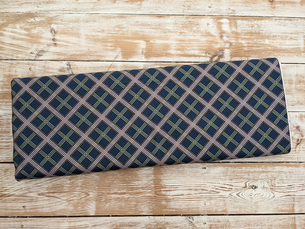 Thumbnail: Rolled fabric with navy, green, and pink plaid; Wooden background; The Fabric Squirrel.